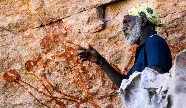 An Indigenous guide at Injalak Hill explaining the rock art.