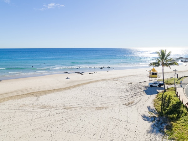 clear skies and white sand on a sunny day at Rainbow Bay