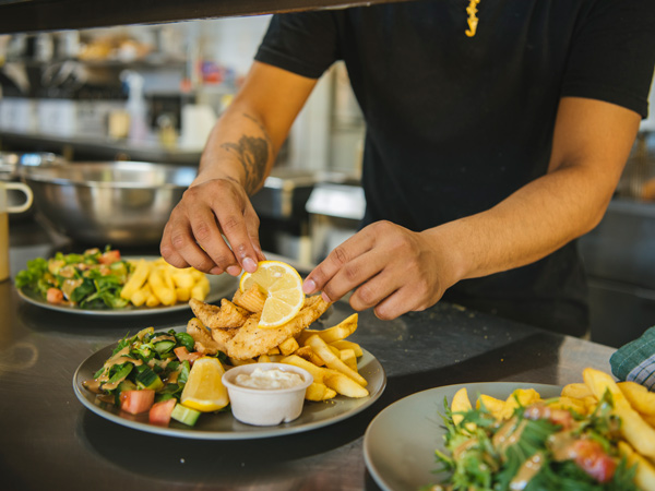 Serving fish and chips at Epikur at Darwin Ski Club. 