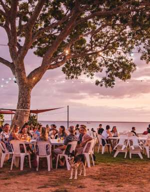 People relaxing at Darwin Ski Club at sunset