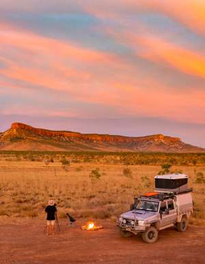 a man standing with a bonfire setup at sunset, the Kimberly and Gibb River Road trip