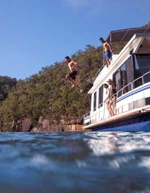 Couples enjoying a day out on the Hawkesbury River on their houseboat.