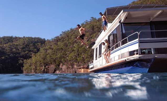 Couples enjoying a day out on the Hawkesbury River on their houseboat.