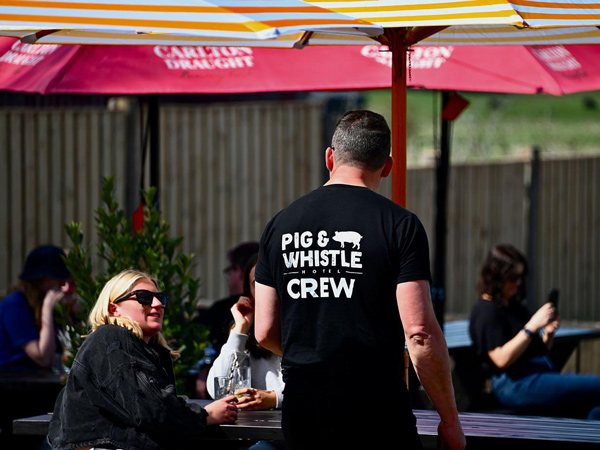 a pub staff taking customer orders at Pig and Whistle Hotel
