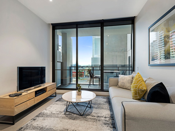 the living area with balcony at The Eminence Apartments by CLLIX