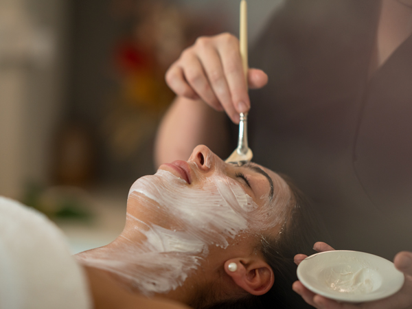 a woman having a facial treatment at Essentia Spa, Lizard Island Resort