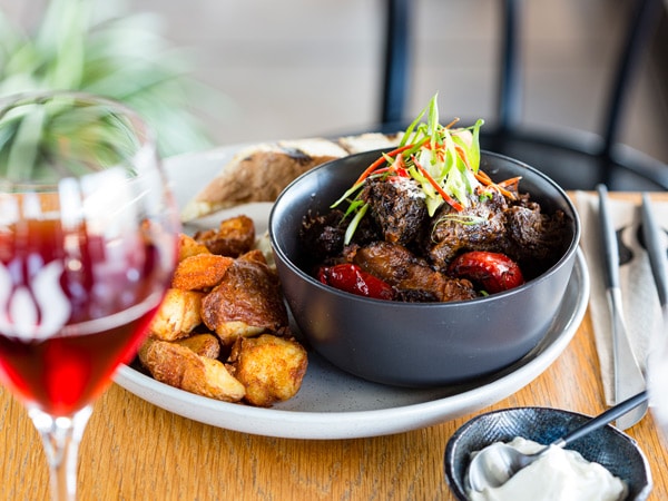 an appetising dish with a glass of wine on the side at Wharf 1, Darwin