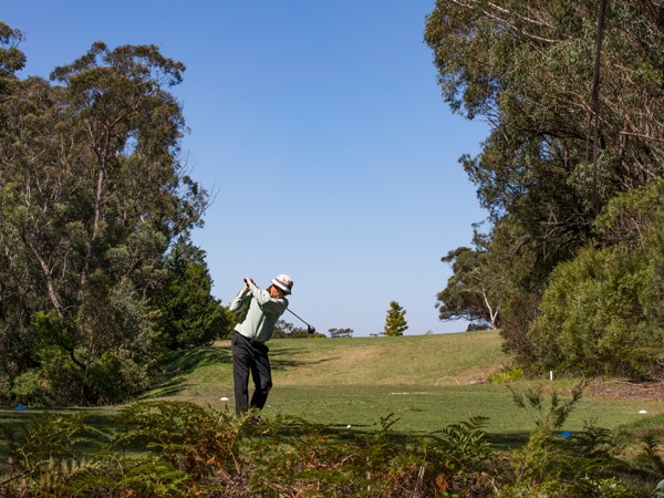 a man playing golf at Leura Golf Club in the Blue Mountains