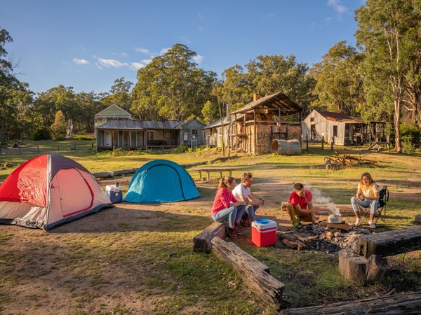 campers gathering around a bonfire setup on the Private Town campground, Yerranderie Regional Park