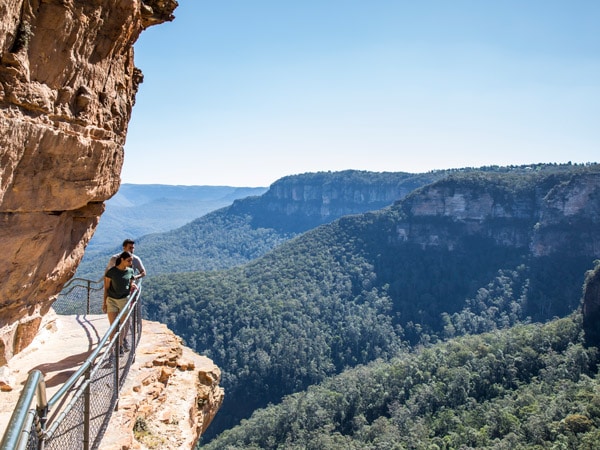 a couple enjoying a walk along the Wentworth Falls Track in the Blue Mountains National Park