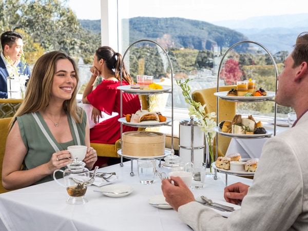 a couple enjoying a high tea experience at Wintergarden at the Hydro Majestic