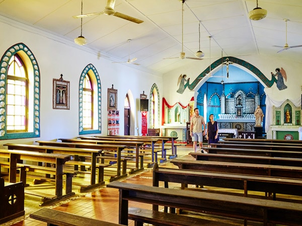 two people visiting the Sacred Heart Church, Beagle Bay