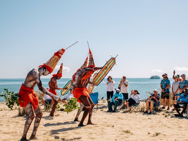 an indigenous group performing in front of guests