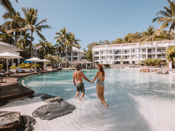 a couple enjoying at the pool of Peppers Beach Club & Spa