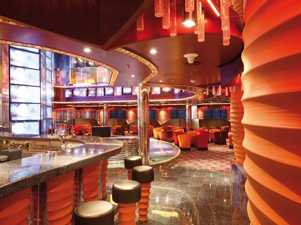 the vibrant interior of Carnival Luminosa's Altair Nightclub