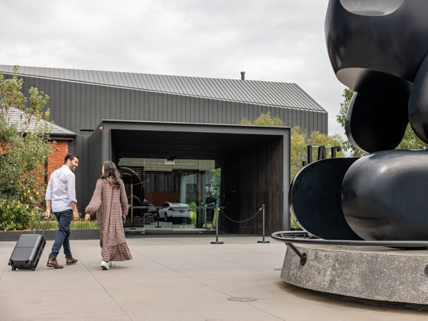 a couple carrying luggage while heading into Jackalope