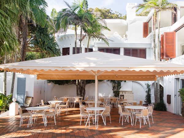 plenty of chairs under a huge umbrella at Raes Cellar Bar