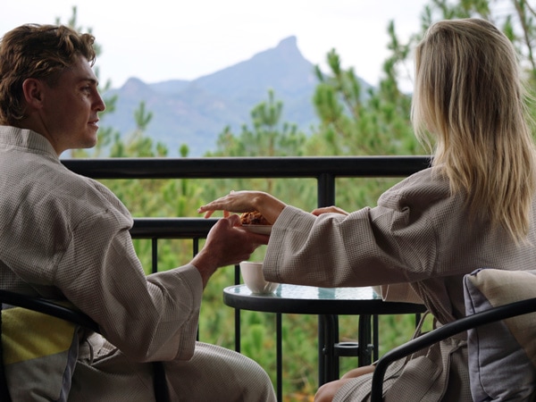 a couple relaxing on the balcony at Ecoasis Retreat