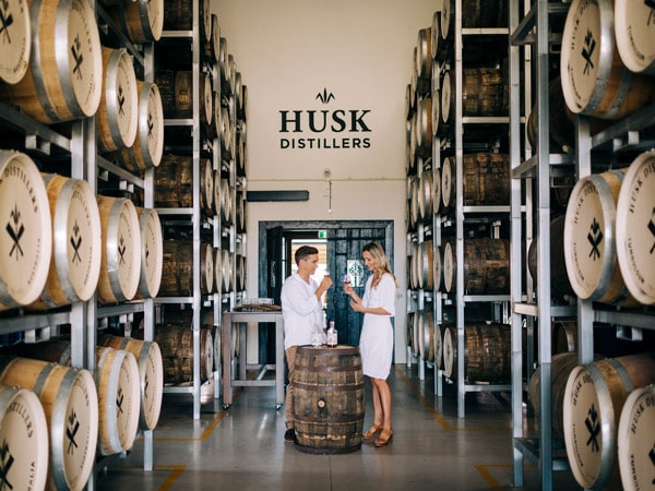 a couple enjoying rum tasting at Husk Distillers