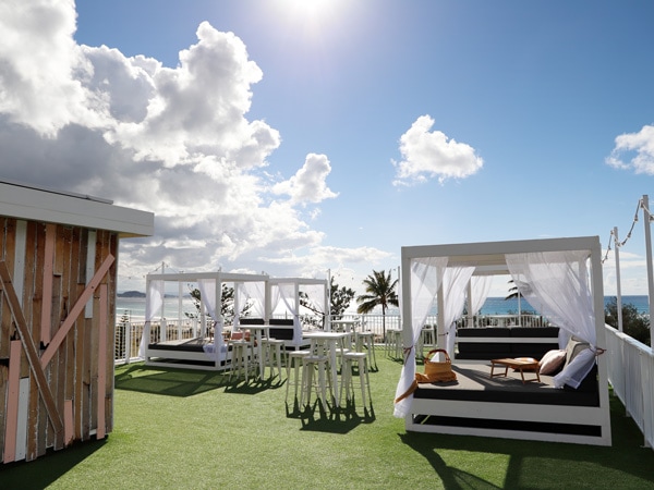 a roof deck with comfortable seating areas at Pink Hotel