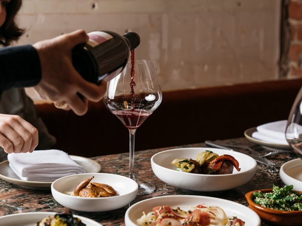 pouring wine into a glass at Fino Vino, Adelaide