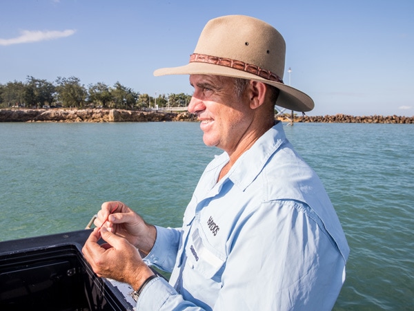 a man out fishing in Darwin Harbour
