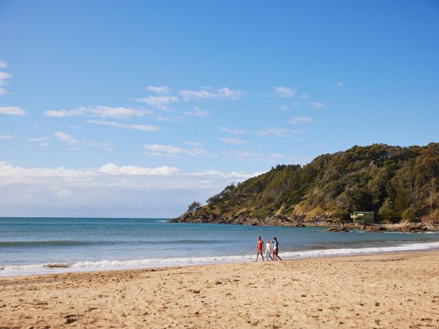 friends walking along Charlesworth Bay Beach, Coffs Harbour