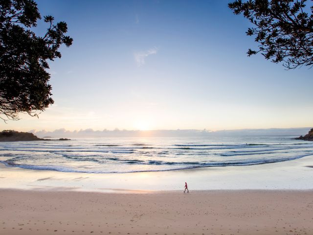 a woman enjoying a morning walk at Jetty Beach, Coffs Harbour