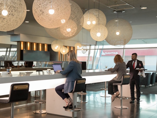 people sitting while working on their laptops inside the Qantas Domestic Business Class, Melbourne