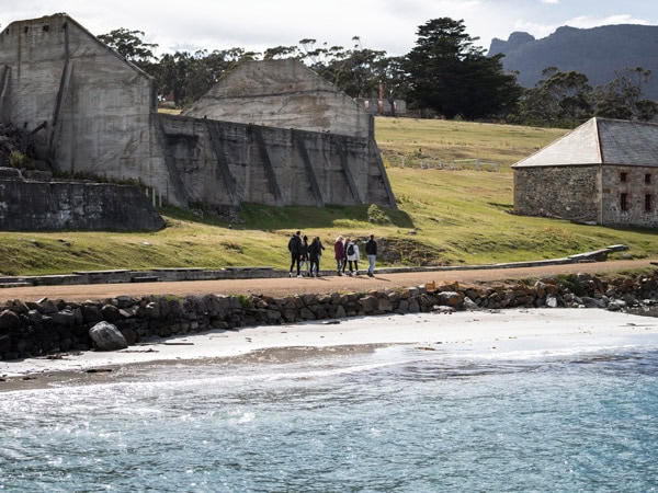 hikers walking across the heritage-listed Darlington settlement, Maria Island Walk