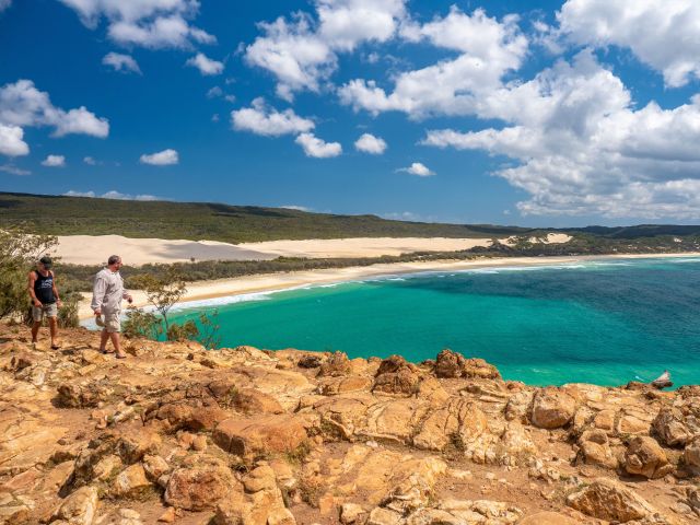 people walking on Indian Head Headland at one end of Seventy Five Mile Beach opn k'gari
