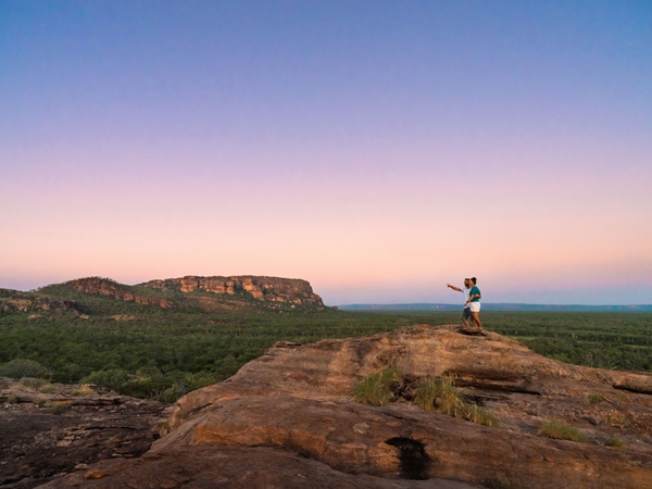 a couple admiring the sunrise over Nawurlandja Lookout