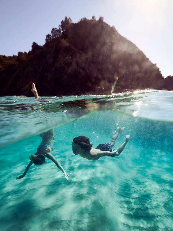 Kids swimming at Tallows Beach in Byron Bay, NSW