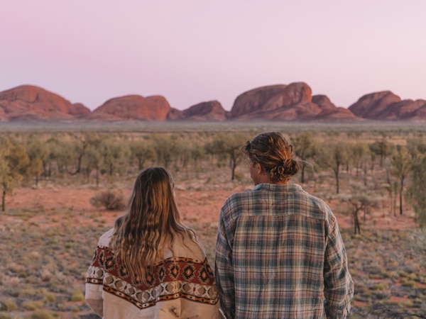 Couple admiring Kata Tjuta. (Image: Tourism NT and Salty Aura)