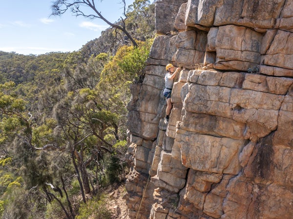 a woman rock climbing at Morialta Conservation Park
