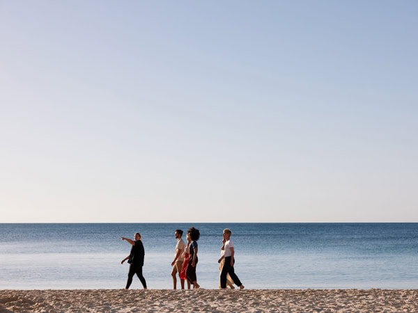 a group walking along the beach during the Southern Cultural Immersion tour in Adelaide