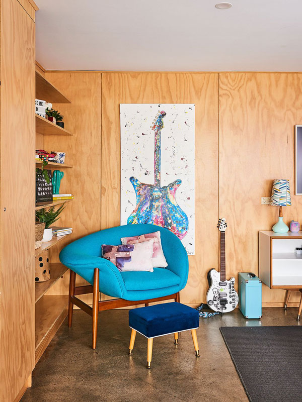 a blue chair with a guitar painting on the wall at Bobby Three One Oh, Ballarat