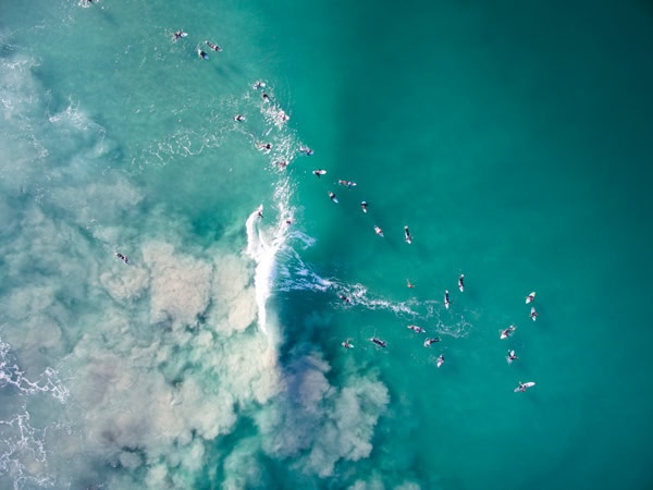 surfers hitting the waves at Trigg Beach, Perth