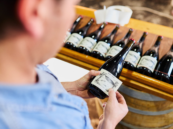 a man holding a wine bottle at Eastern Peake, Ballarat