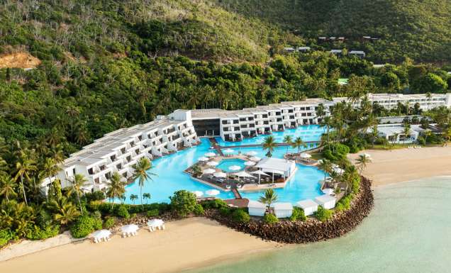 an aerial view of InterContinental Hayman Great Barrier Reef with a pool next to the beach