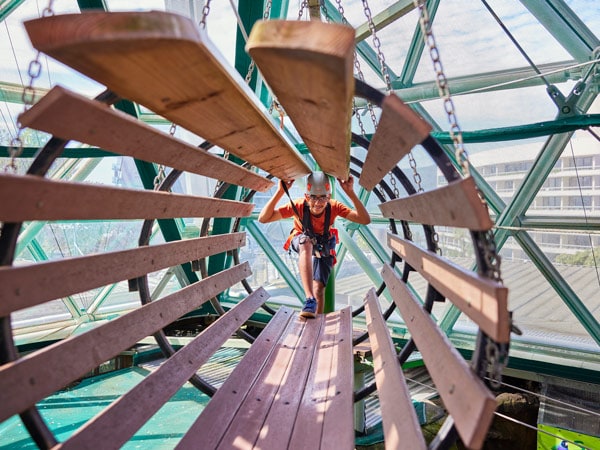 a person conquering the obstacle course at Cairns ZOOM and Wildlife Dome