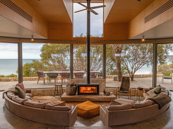 Dune House with the wood fire in the centre of the living room. 