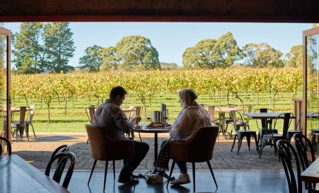 a couple enjoying food and wine at Bendooley Estate, Southern Highlands wineries
