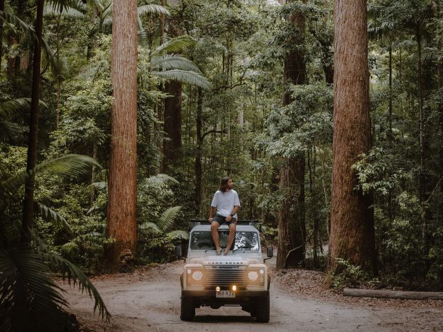 man sitting on 4wd in the middle of Pile Valley on k'gari camping