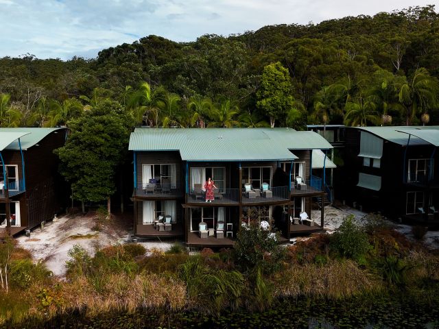 woman standing on balcony of room at Kingfisher Bay Resort k'gari accommodation