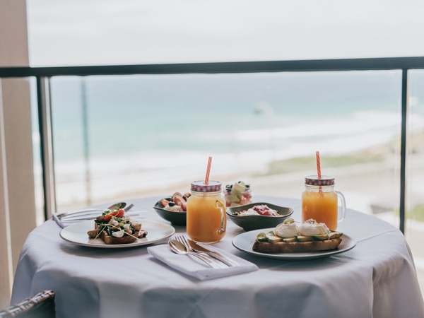 food on the table by the balcony with beach views