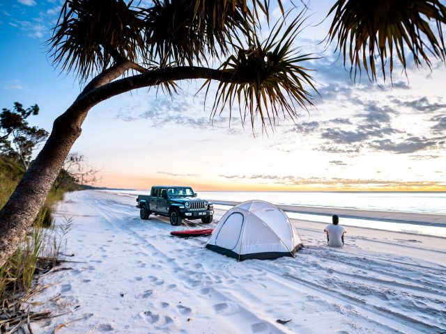 person with 4wd camping on a k'gari beach