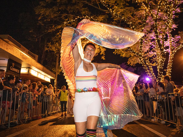 a street parade participant in a colourful costume, Carnivale, what to do in Port Douglas