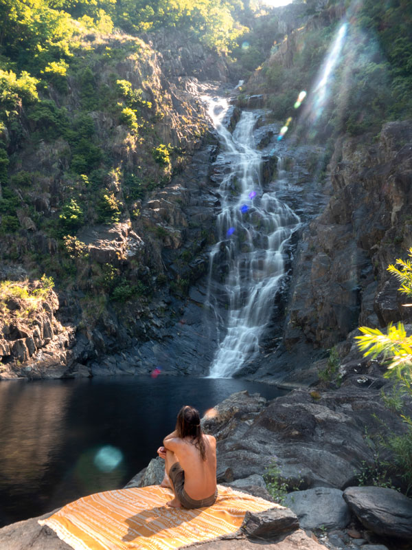 a man sitting next to the Spring Creek Falls, Port Douglas