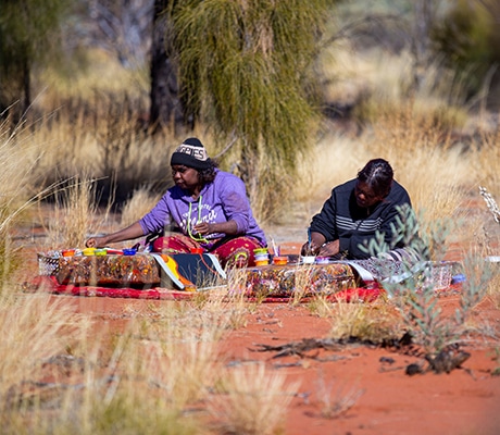 Women painting Desert art at Maruku, Uluru